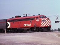 CP train 12, the Toronto section of "The Canadian" heads south across Major Mackenzie Drive in Vaughan, Ontario. FP7A CP 4069 is leading, a single FP7A in this range being typical power on this run at the time. <br><br>CP 4069 is approaching the power-operated switch at the north end of "Elder" passing siding. <br>By 1991 Elder siding had become the connection to and from CP's then-new Vaughan Intermodal Terminal. <br><br>  Just over 4 months after this picture, on October 29 1978 VIA assumed  responsibility for CP's passenger rail services. An early casualty was  the Toronto section of the Canadian, CP trains 11 and 12. <br> The VIA national timetable for 1979 shows VIA had rationalized  passenger services with the "Canadian" trains 1 and 2 between Montreal  and Vancouver while the "Super Continental" trains 3 and 4 ran between  Toronto and Vancouver. Winnipeg was one station that both trains used  - therefore the recommended place to change between trains.