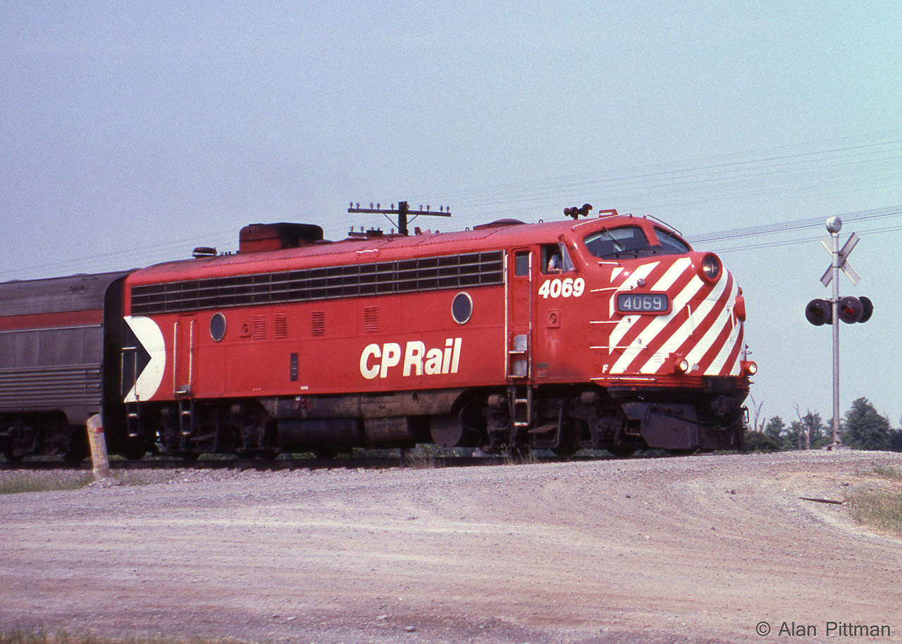 CP train 12, the Toronto section of "The Canadian" heads south across Major Mackenzie Drive in Vaughan, Ontario. FP7A CP 4069 is leading, a single FP7A in this range being typical power on this run at the time. 
CP 4069 is approaching the power-operated switch at the north end of "Elder" passing siding. 
By 1991 Elder siding had become the connection to and from CP's then-new Vaughan Intermodal Terminal.   
Just over 4 months after this picture, October 29 1978, VIA assumed responsibility for CP's passenger rail services.  VIA's visible impact was limited in the first year, but became more obvious after that with repaints and mixed equipment. Apparently VIA moved "The Canadian" to CN tracks in 1990, simultaneous with dropping the "Super Continental".