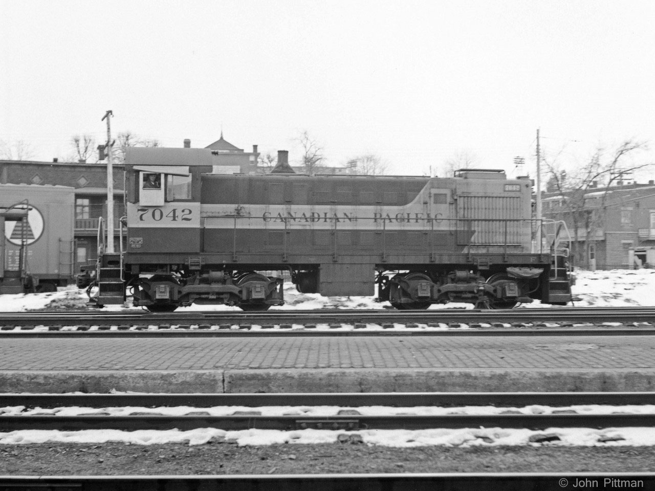 Winter of 1970-71.  Venerable ALCO S-2 switcher CP 7042, is working Trois-Rivieres yard, where it was regularly assigned. My source indicates it was built by ALCO Schenectady in 1946, so it was then about 24 years old. The ALCO cast metal manufacturers plate is on the bottom right of the cab, above the cast CP class DS-10d plate. 
I was the only visible railfan in T-R the two years we lived there.  The engineer seems be looking in my direction, hope I didn't annoy him.   
Camera was a Yashica Mat twin lens reflex. Best suited for slow or stationary subjects, as the ground glass viewfinder reversed everything.