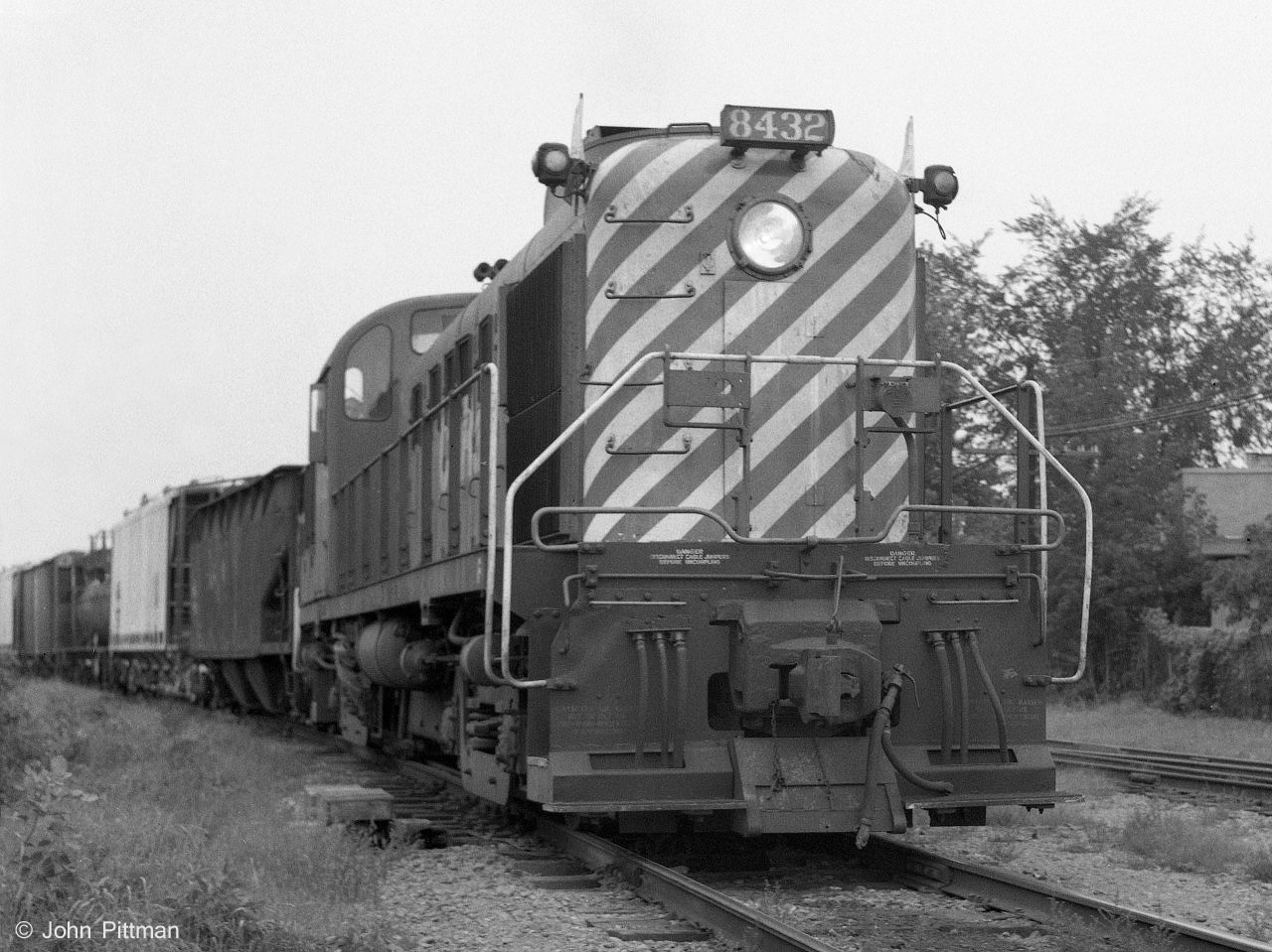 CP 8432, an MLW RS-3, leads an extra westbound out of Trois-Rivieres yard on CP's St Lawrence River north shore line.  Taken at the Rue Bonaventure grade crossing.  
Ahead the train may take the branch line north to CP Shawinigan yard, or continue west to Montreal.