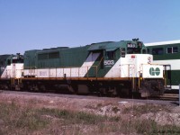 GP40TC GOT 503 and 504 are sitting out the weekend in GO Transit's Willowbrook Yard, at the time maintained by CN. One of the original batch of locomotives purchased for GO Transit, it had previously been CN 603, GO 603, and GO 9803, before adopting GO's long-term green and white colour scheme and its final GO Transit unit number 503. Some of GO's original bi-level coaches can be seen the next track over, first deliveries began in 1977. <br><br>
The GP40TC (TC = Toronto Commuter) was unique to GO transit, being more or less a GP40 built on an SD40 frame. The nose is shorter and the long hood extended to provide space for an auxilliary power diesel generator set. The fuel tank occupies a fraction of the space between the trucks. <br><br>
GO Transit's GP40TC fleet 500-507 were sold to Amtrak in 1988, renumbered 192-199 and modified for Amtrak's purposes.  They were renumbered AMTK 520-527, and got de-turboed. Some remain active in 2015 for work trains etc, having outlasted Amtrak's F40PH locomotive fleet. 