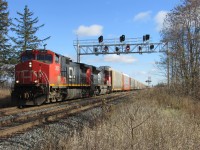 CN E231 is crawling through Winston Churchill BLVD just east of Georgetown. The Green signal is for one of the last CN Q144's. :(