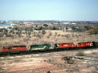Seen from a pile of old tailings of the former brick works to the west of Milton. CP train 923 starts its climb along the Niagara escarpment. . The GP9 trailing was headed to London for yard service.  