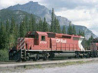 CP SD40-2 5720 looking right at home in the Canadian Rockies. WB with four SD40-2,s on a general freight, waiting for the Canadian to pass out of Banff station. 