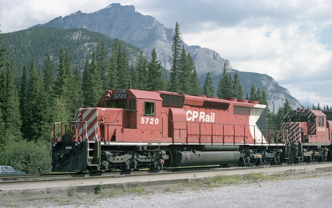 CP SD40-2 5720 looking right at home in the Canadian Rockies. WB with four SD40-2,s on a general freight, waiting for the Canadian to pass out of Banff station.
