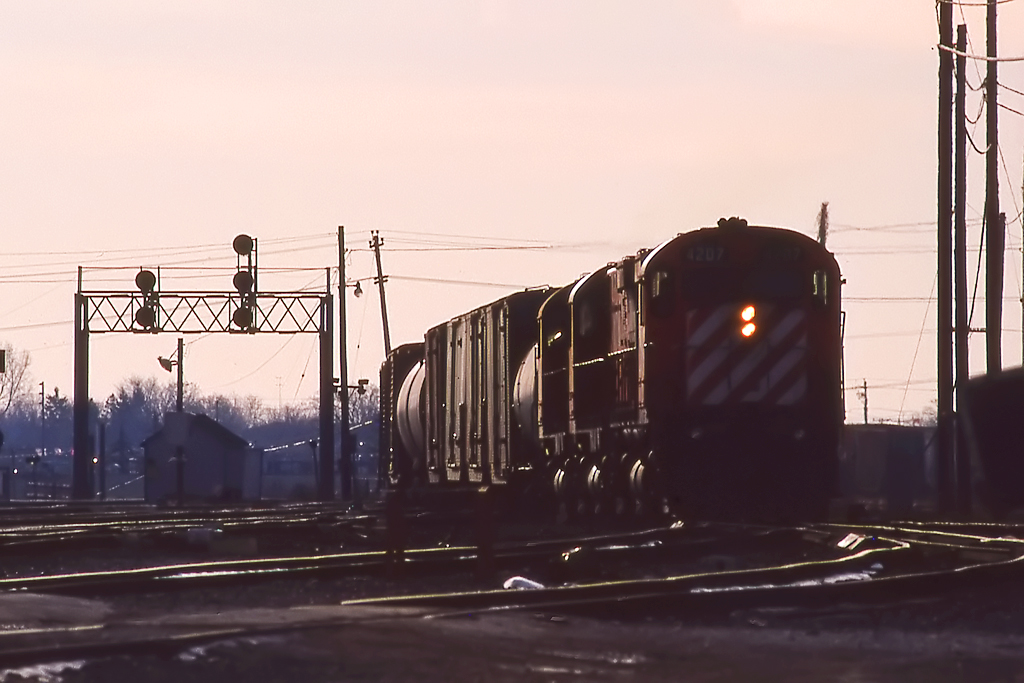 3 424's bring an eastbound into Agincourt Yard at sunset.