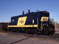 Only one of its kind in Canada, RaiLink painted B-unit switcher 1200 was having a rest while a pair of ex-CN SW1200RS were switching cars in Hamilton's Stuart Street yard. <br>
Originally built as IC 9203B in Feb 1940, it was the cabless B-unit half of an EMD "TR" switcher pair - often nicknamed "cow and calf". Both parts of the TR were based on the EMD NW2, and it originally had the NW2-style dip in the hood in front of the (absent) cab. IC renumbered it to IC 1026B in 1956. <br><br>
In 1998 this locomotive was 58 years old - sort of. I expect the frame and some other parts were that old. But IC had rebuilt it into an "SW13B" in 1972, with many parts replaced, the hood line flattened, and re-numbered to IC 1300B.  Later becoming ICG 1300B, it passed to the Paducah & Lousville as PAL 1300B. <br><br>
The unit was acquired freshly painted for RaiLink Hamilton in 1998, and as I recall was active for at least a couple of years. My 2005 Cdn Trackside Guide lists it in [brackets] indicating stored unservicable. Mark Macauley posted an image of it from October 8 2008 when scrapping was in progress  - http://www.railpictures.ca/?attachment_id=21772