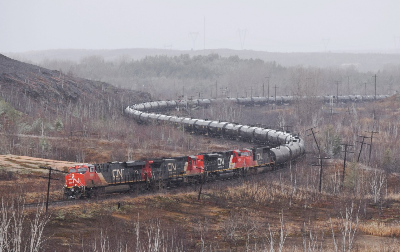 A four unit lashup including an SD70ACe eases a loaded crude oil train through Sudbury's first real snowfall. Power consisted of CN 2884, CN 2134, CN 8103 and CN 5647.