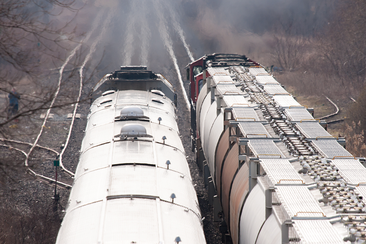 The great train chase is....over. VIA 77 easily scoops a down to its knees CN freight at the top of the escarpment.