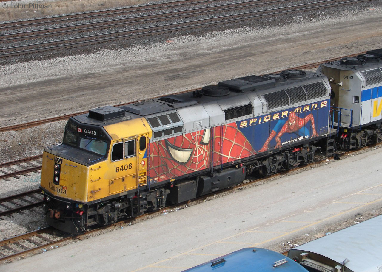 VIA 6408 still wears Spiderman 2 wrap in April 2011, years after the mid-2004 premiere of the movie it advertises.  The wrap is in much better shape than 6408's yellow paint.