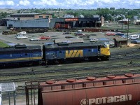 This is as much about the main subject as the background.
I am not certain about the pattern, but VIA must have been switching and servicing their power as it came through Calgary. This set came off an eastbound "Canadian", the only train operated with locomotives passing through Calgary at the time.
In the background is the turntable and roundhouse that seemed to have little use, except for the switchers.