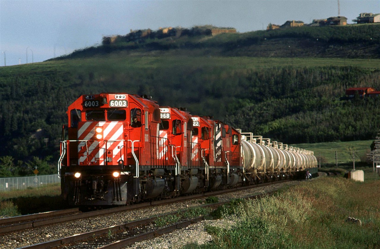 A unit train of Alberta Gas Products cars heads west on this August evening.

Some houses in the background would seem to be in an ideal position for observing action on CP's Laggen Sub.