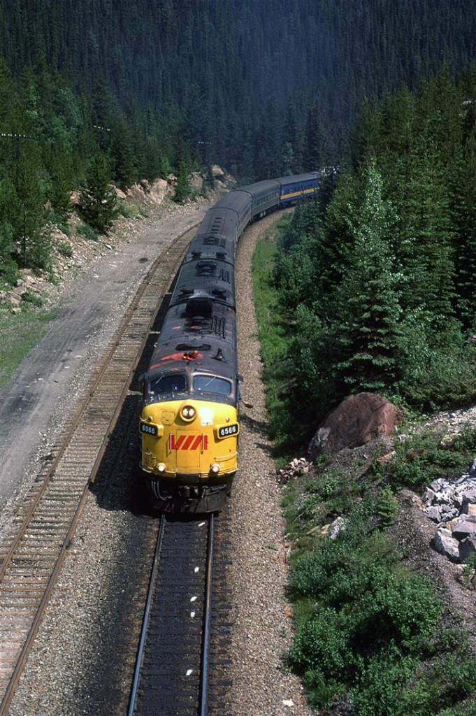 VIA's eastbound "Canadian" climbs Kicking Horse Pass between the spiral tunnels. The pealing paint on the lead locomotive is just one clue that this was once in CP colours.