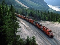 From the same vantage point as the previous picture, the eastbound manifest has cleared both spiral tunnels and it by Partridge siding.
In the background, can be seen the tracks as they hug the side of Cathedral Mountain as they descend into Field.