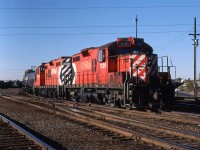 !520 and 1536 are working the east end of the hump classification tracks, assembling a train for departures elsewhere. The tracks on the ridge at far right, with the wooden stairway, are the CN connecting tracks from their facility (Sarcee Yard) to CP's Alyth Yard.