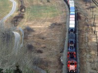 An eastbound relatively hot train usually came into town about the same time as VIA's #2. Today, it is preceding the passenger train. It is through Brickburn Siding, and is now in the center of Edworthy Park.
I believe that the fencing was fairly new at the time, and I suspect that there is lots more these days.