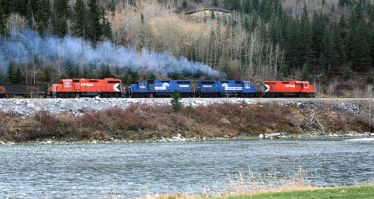 Looking across the Bow River near the east switch of Brickburn, the Exshaw Turn is headind toward Kieth Yard in west Calgary. It will likely head west from there to switch the huge gravel and Cement facility at the door to the Rockies.