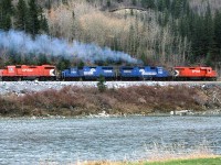 Looking across the Bow River near the east switch of Brickburn, the Exshaw Turn is headind toward Kieth Yard in west Calgary. It will likely head west from there to switch the huge gravel and Cement facility at the door to the Rockies.