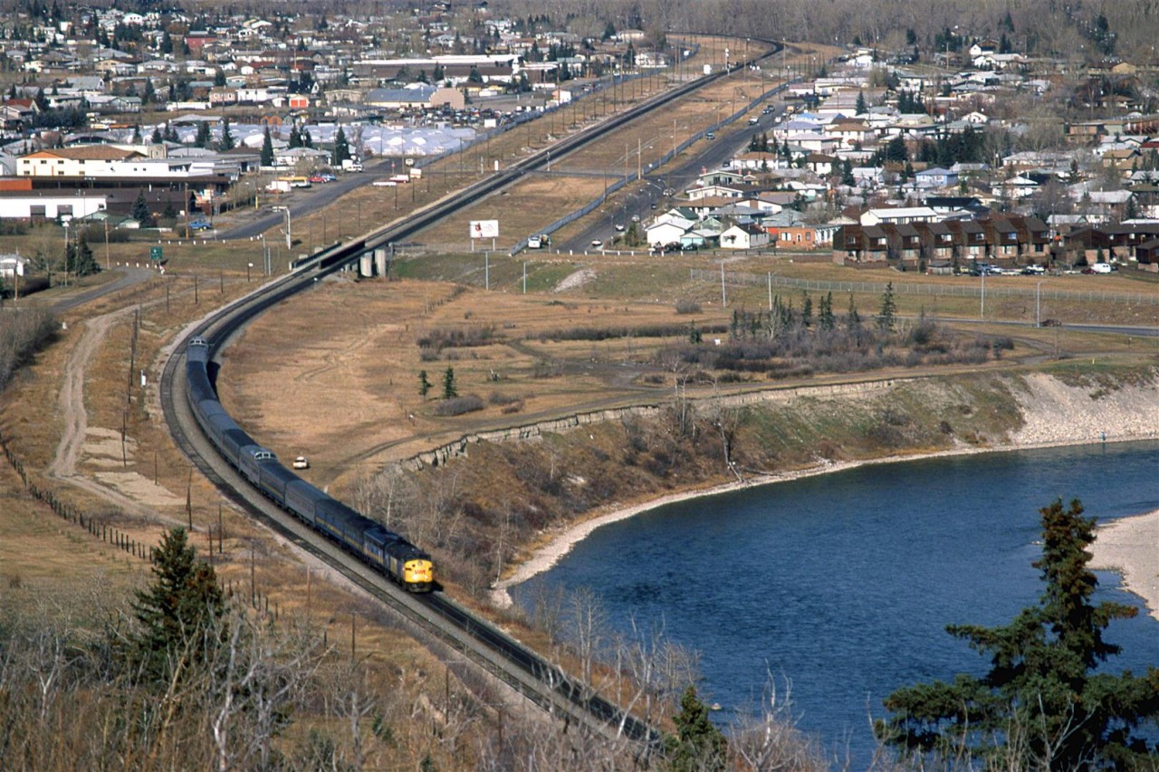 Brickburn Siding, the Bowness community in west Calgary, and the Bow River are seen in this photo. Perhaps that is a railfan parked down by the train.