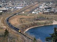 Brickburn Siding, the Bowness community in west Calgary, and the Bow River are seen in this photo. Perhaps that is a railfan parked down by the train.