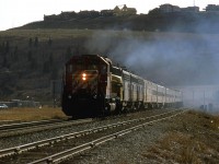It looks like all three VIA F units are putting out exhaust - albeit with quite a bit of oil being burned as indicated by the blue smoke. Perhaps, someone figured that the old units wouldn't make it to Vancouver. 
The train is on the main adjacent to Brickburn Siding. If one looks very carefully, the east signal for Brickburn may be seen above the chain link fence at the extreme left. 