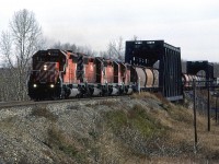 A westbound manifest train crossed the two bridges used to span the Bow River in west Calgary. In about another kilometer, the train will be at the east switch for Kieth Yard, a facility built to handle bulk commodity trains.