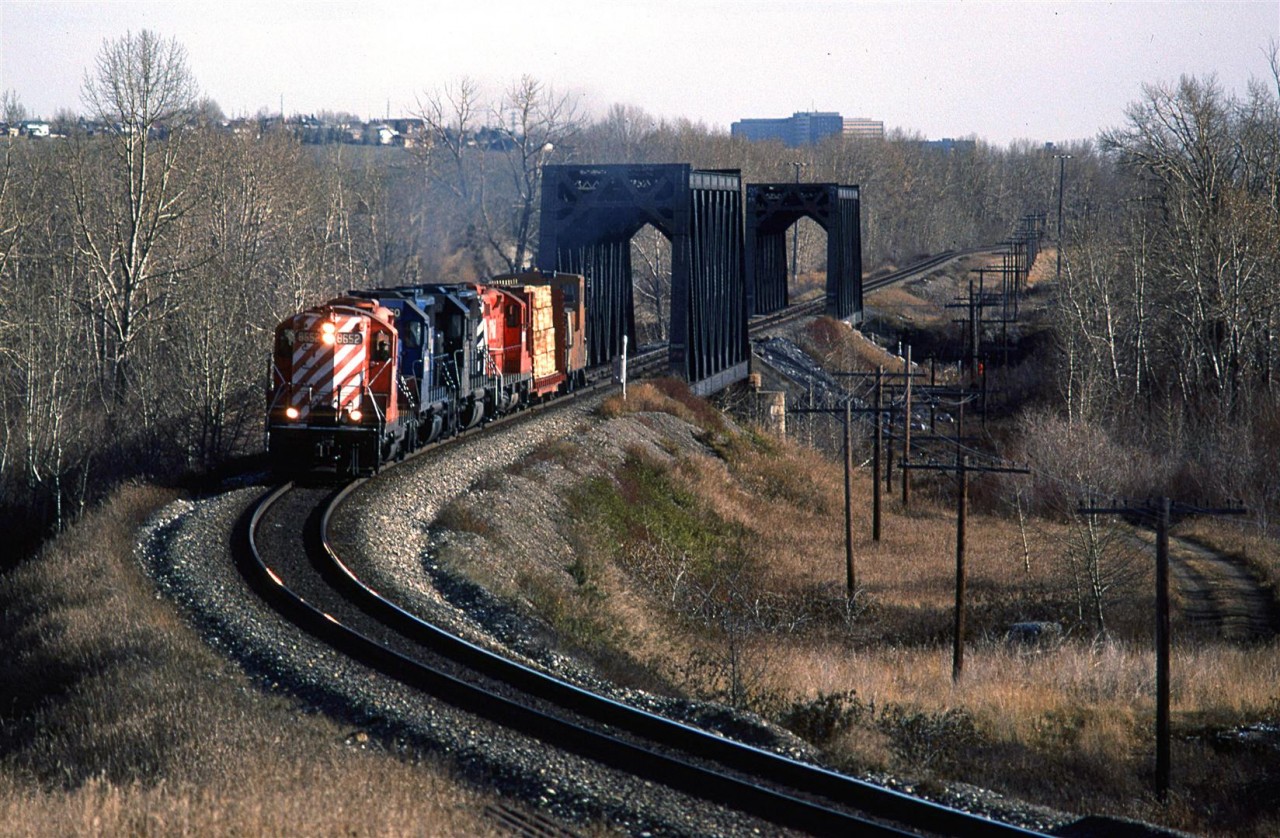 A short Exshaw Turn is crossing the Bow River and will shortly stop in at Kieth Yard before continuing west to Exshaw (and maybe Canmore - I don't know there the lumber was destined to be unloaded). I like the high nosed GP's and went out of my way to photograph them when they were assigned the duties for this regular train. It was a bonus to have the two CR GP-38's included.