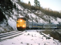 In retrospect. I am not so certain why I spent most of this day in the shade. I guess I thought that the curved track in the shade was more interesting than straight track in the sun.
VIA's eastbound "Canadian" enters the S curve just east of Brickburn with a shiny 6305 leading.