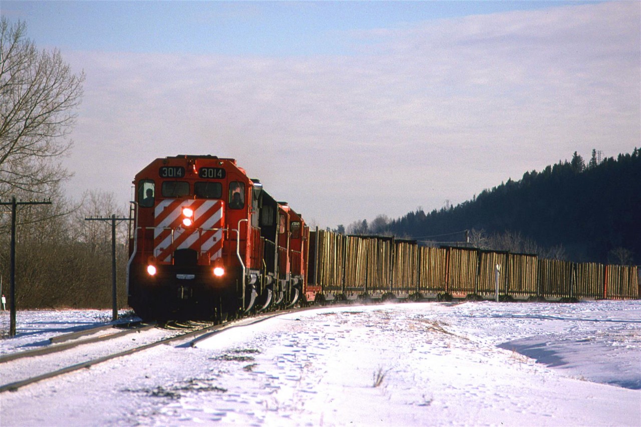 By all accounts, this looks like the Exshaw Turn - 4 axle power, approximately the right time and weird consist. My guess is that the timber cars are destined for Kieth yard, but I cannot be certain. The day is still quite cold. There does not appear to be any melting, but I would best that there has been quite a bit of sublimation.