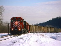 By all accounts, this looks like the Exshaw Turn - 4 axle power, approximately the right time and weird consist. My guess is that the timber cars are destined for Kieth yard, but I cannot be certain. The day is still quite cold. There does not appear to be any melting, but I would best that there has been quite a bit of sublimation.