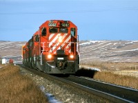These movement really puzzled me. Were they simply power re positioning? I would often see cab hops between Kieth yard in West Calgary and the Shops at Alyth, but this is west of Kieth. 
For re positioning, why wouldn't CP simply stick a few extra engines on a hot train?
Any ideas?
This is also when I began to discover the wonderful topography just west of Calgary. I loved shooting in the Bow Valley between here and the far side of Cochrane.