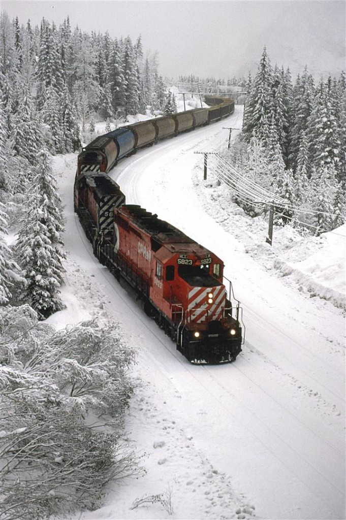 This grain train eases down the slope through Kicking Horse Pass. It is between the Spiral Tunnels. The snow on the ground and in the air muffles the sound significantly.