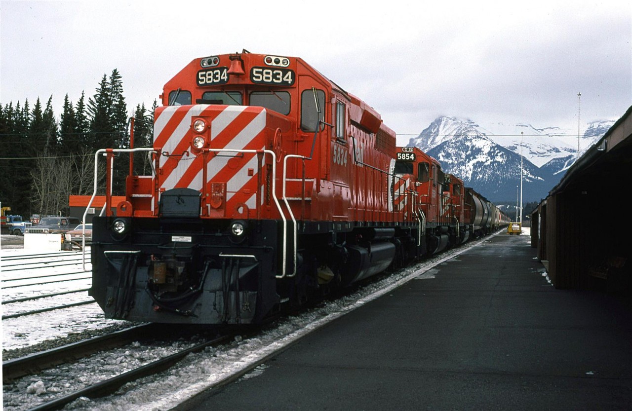 After cross country skiing for a while, we returned to Banff and found this grain train sitting at the station. Perhaps it was waiting for an eastbound train to pass?
Note the open speeder in the background and the fresh paint on the two lead locomotives.
This is likely my last photo taken in 1985