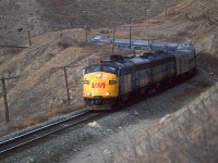 The eastbound "Canadian" is just east of Cochrane along the bluffs that bound the Bow River. Unit 6566 was a regular on the train at this time.