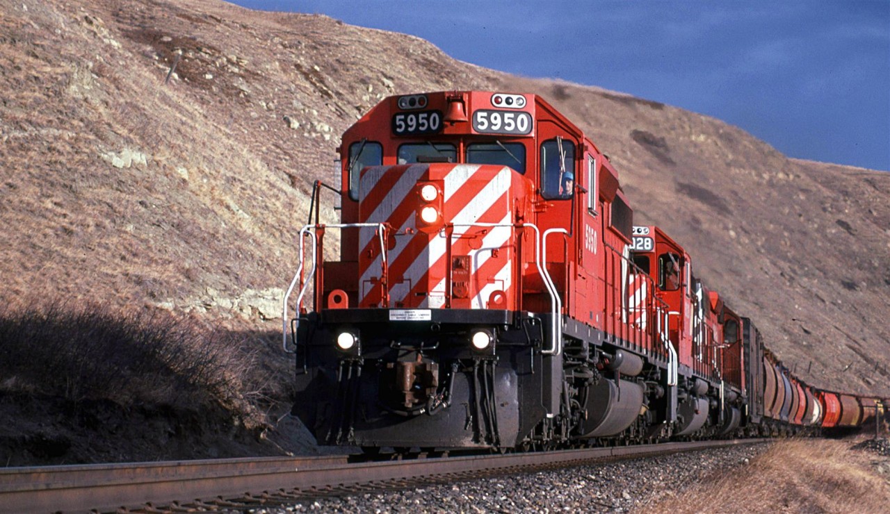 At 5 to 3, the sun is starting to get pretty low in the sky. What appears to be a grain unit train is really a manifest with all sorts of different cars.