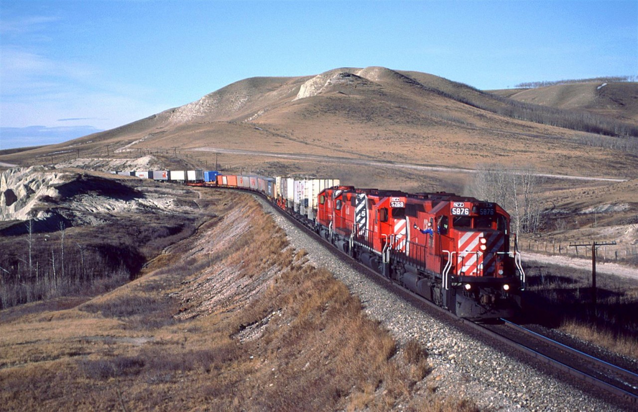 A friendly wave from the engineer as this eastbound "hotish" train approaches Glenbow.