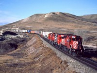 A friendly wave from the engineer as this eastbound "hotish" train approaches Glenbow.