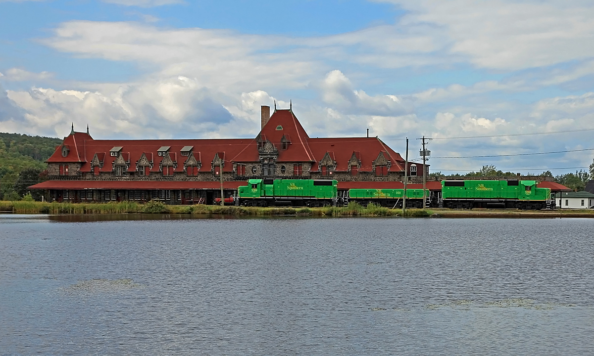 NBSR 908 has just set out a cut of cars in the yard on the south side of McAdam Station and is now returning the power to the main on the north side to rejoin it's train, after which a new crew will take over for the remainder of the trip to St, John