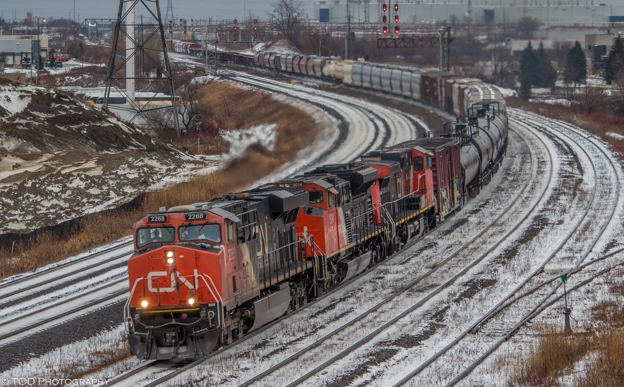 Finally a bit of snow!

With a bit of snow on the ground, CN 369 comes through Whitby under the Hopkins St overpass, with a trio of units, featuring a high-cab headlight SD70M-2 and an old and faded C44-9WL.

CN 2268 ES44DC, CN 8014 SD70M-2, CN 2503