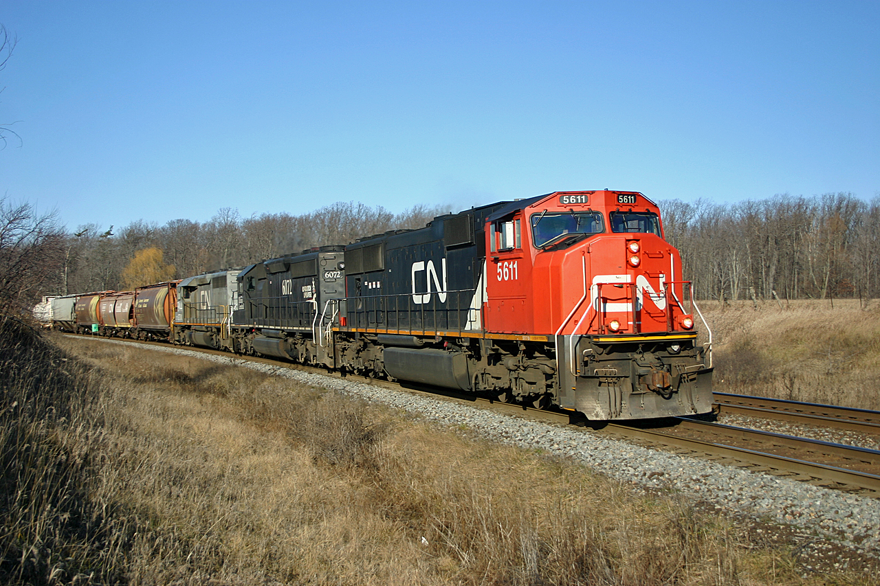 I'll be home for Christmas.< /b>  On a typical Southern Ontario Christmas Eve (sunny skies and no snow!), we see CN 435 rolling through Tansley.  Its 1352 and no doubt the London crew is eager to get home to their families.  Although not the newest or most powerful units on the railway, CN 5611, IC 6072 and GTW 5944 will have no trouble getting the train over the road.  The railway is entering the Christmas shutdown, away from home crews are heading home with trains operating early.  It will be a 'Silent Night' as CN shuts down almost all of their operations to allow their employees to spend Christmas with their families.  Come mid-afternoon on Christmas day, things will slowly ramp up with normal operations resuming on boxing day.