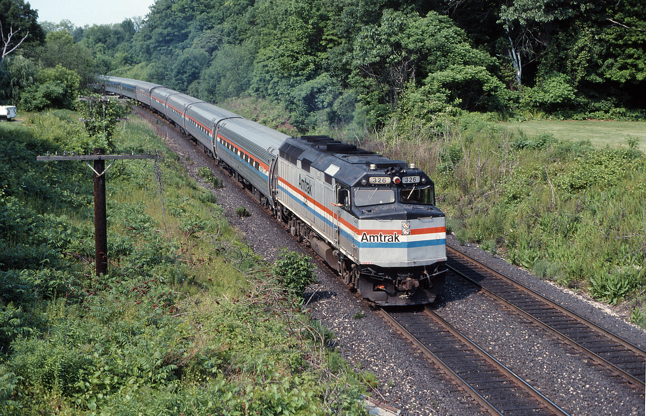 VIA 92 scoots under Snake Road with a friendly wave from the engineer.  Behind the Amtrak equipment is a VIA train set consisting of VIA HEP cars and an F40 on the tailend.