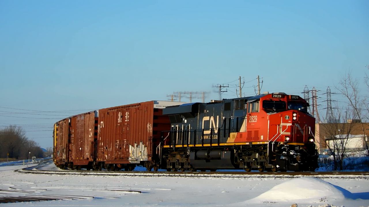 One of CN's newer ES44AC's pulls a long mixed freight train heading east. They are in the process of going around the elevated curve at SNS Portage Junction, and are about to pass through Fort Rouge Yard.
