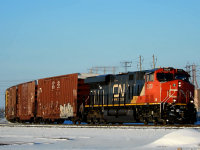 One of CN's newer ES44AC's pulls a long mixed freight train heading east. They are in the process of going around the elevated curve at SNS Portage Junction, and are about to pass through Fort Rouge Yard.