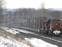 A mild March winter day..sees this "occasional" intermodal train 150 with all marine containers heading east with a trio of BNSF power.  Anyone know what the origin /destination of this train was, the WB counterpart was 151; it disappeared quite some time ago. 