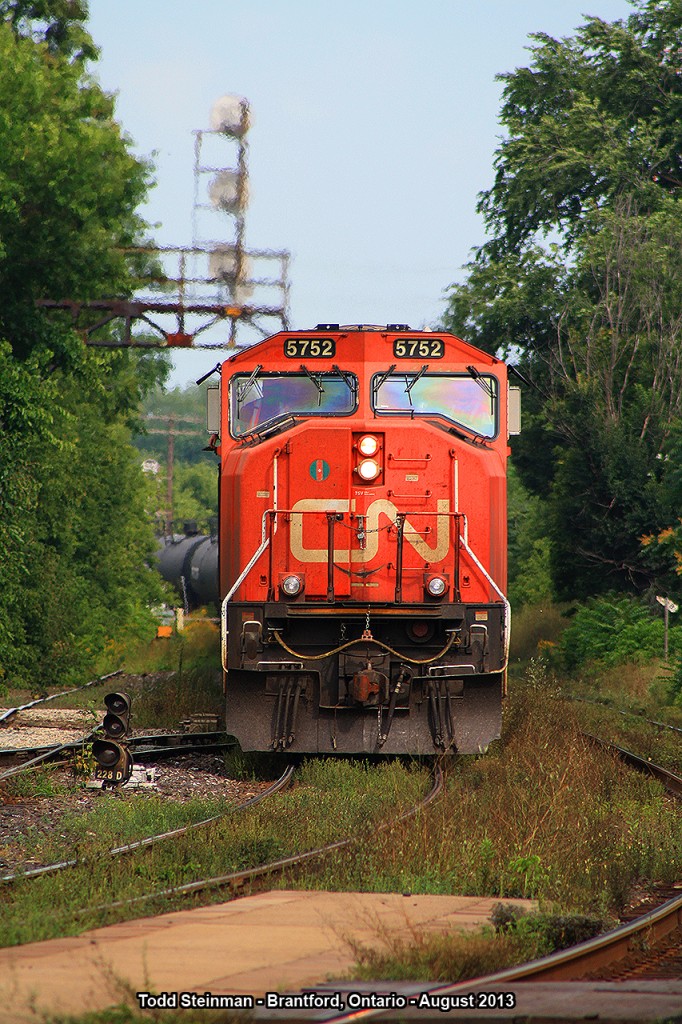 The sun has already started to set on this warm August night, as the front of CN 5752 appears with a long string of tanker cars crawling it's way past the Brantford station. Soon, an eastbound VIA set will make it's daily evening visit at the station.