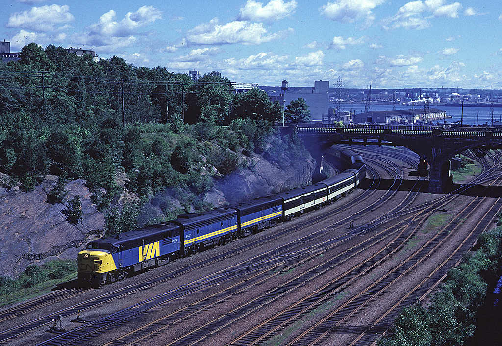 Via Rail #15 has just left Ocean Terminal starting into its run to Montreal powered by an interesting combo of FPA-4, FP9A, FPB-4. I'm shooting from the Tower Road bridge watching the train pass under Young Ave. Halifax harbour is in the background with Imperial Oil's Dartmouth refinery in the background.