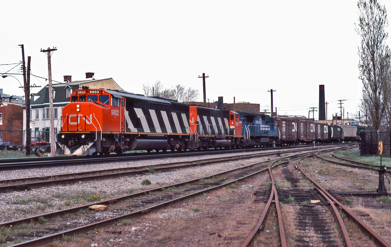 CN 9902, CN 5267 and Conrail 6619 lead a westbound freight through St-Henri.  CN 9902 is an EMD SD60F, built in late 1985 and will only be renumber to the 5502 in 1988.