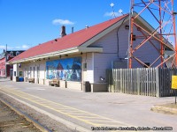 <b> WHAT IS OLD IS NEW AGAIN. </b> The Grand Trunk built the station in Brockville around 1856. The CN made it's alterations to the station around the mid 60's, boarding up the brick exterior and arched windows that dominated the station. <br>
However, not all is lost. As of this year, VIA decided against replacing this structure with a new station, and shed the building of the 'old' and outdated look. It restored the station to almost it's former glory with a red brick exterior, and with new modern windows that give it a vintage 'appeal'. <br>
Although I have not gotten up to photograph the station after it's recent restoration, this photo in 2006 shows how far VIA has come with the 'updating' and 'modernization' of it's stations. The trend here was the red roof, and blue name boards. Of note - the mural at the east end of the station was a sign of things that had oncde passed, and was to come back again to the Brockville station unknown to many at this time. 