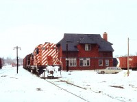 Ready to head South, a pair of old CP RS-18s await their crew at the Orangeville yard. Behind this very obvious CP structure is the station, since moved downtown, now serving as a restaurant. The train consists of only 3 boxcars and a caboose; CP 8773 and 8734 provide plenty of power. Note a pair of ploughs in the far background. This 34.6 mile line was handed over to the Orangeville Railway Development Corp after CP wanted out of local railroad business in 2000, rather quiet as the line to Owen Sound was abandoned in 1995. Since 2000 Cando Contracting has operated the Orangeville-Brampton trackage as the OBRY and business has been steady. A tourist run was added, Credit Valley Explorer, in 2004. And even a new station was opened in May 2007, approximately on the location of the drafty old insul-brick clad structure pictured. The two units were rebuilt into the 1800 series by 1989.