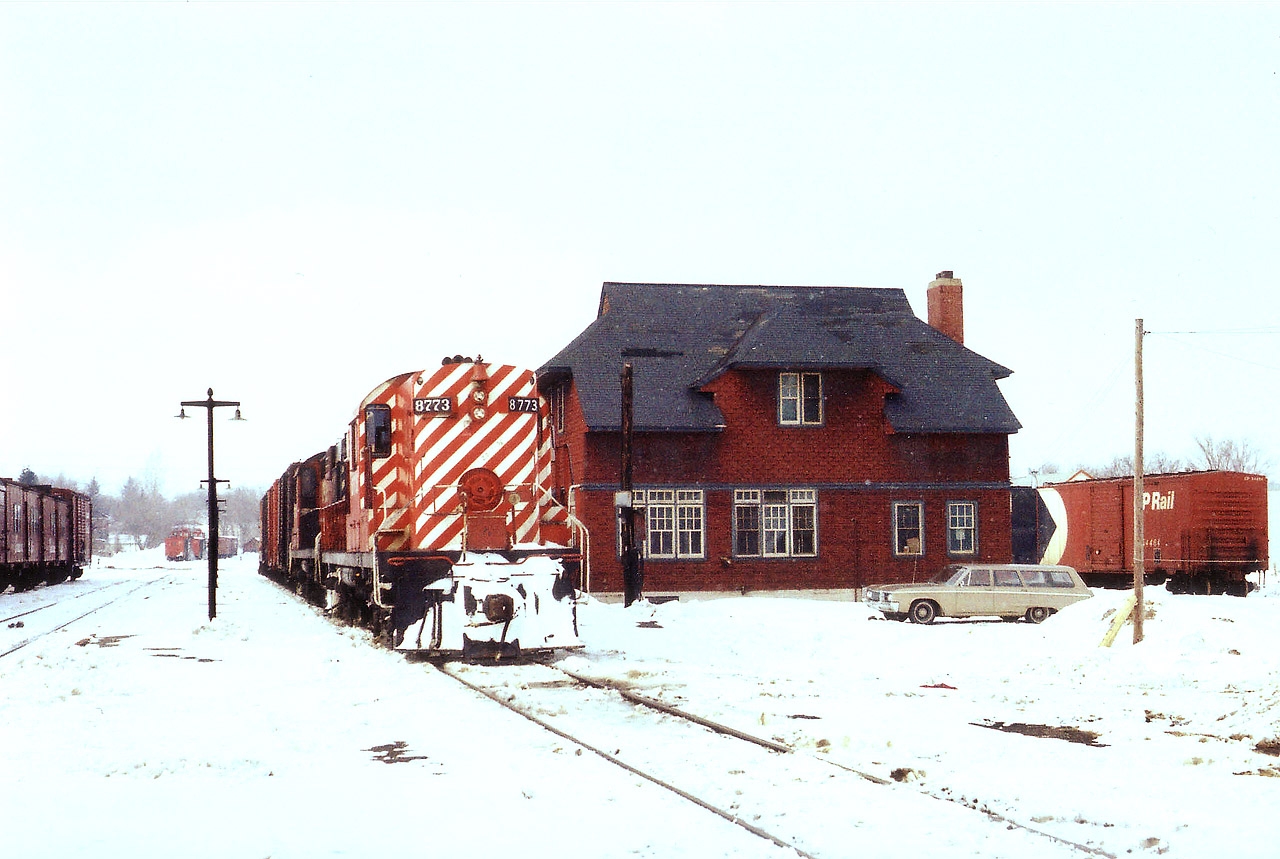 Ready to head South, a pair of old CP RS-18s await their crew at the Orangeville yard. Behind this very obvious CP structure is the station, since moved downtown, now serving as a restaurant. The train consists of only 3 boxcars and a caboose; CP 8773 and 8734 provide plenty of power. Note a pair of ploughs in the far background. This 34.6 mile line was handed over to the Orangeville Railway Development Corp after CP wanted out of local railroad business in 2000, rather quiet as the line to Owen Sound was abandoned in 1995. Since 2000 Cando Contracting has operated the Orangeville-Brampton trackage as the OBRY and business has been steady. A tourist run was added, Credit Valley Explorer, in 2004. And even a new station was opened in May 2007, approximately on the location of the drafty old insul-brick clad structure pictured. The two units were rebuilt into the 1800 series by 1989.